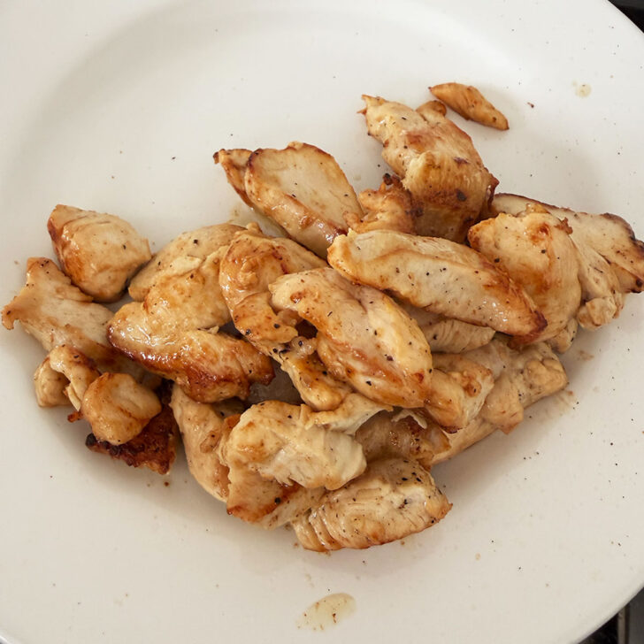 Chicken breast pieces removed to a plate.