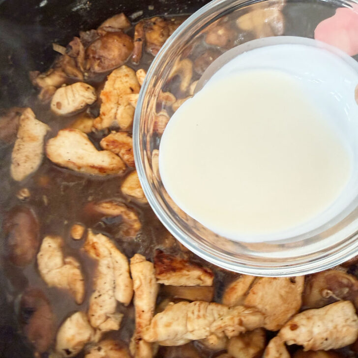 Adding the cream to the skillet.