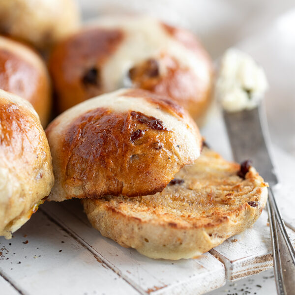 Earl Grey hot cross buns on a serving board.