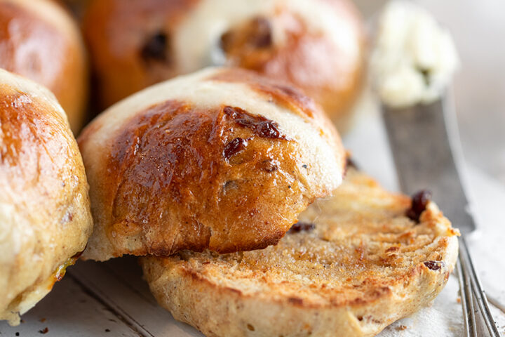 Earl Grey hot cross buns on a serving board.