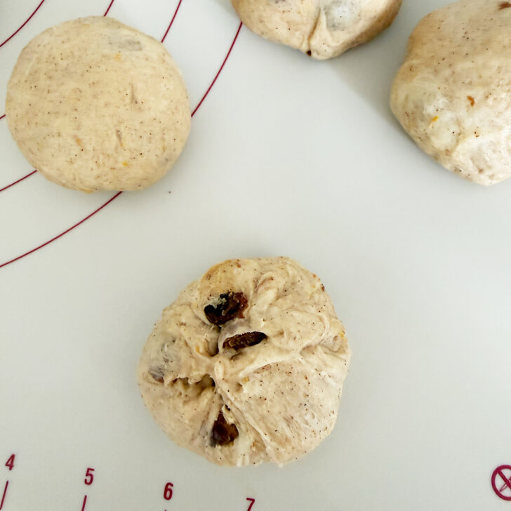 Forming the dough balls into buns.
