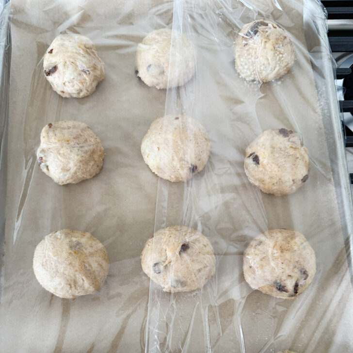 Buns rising under plastic wrap.