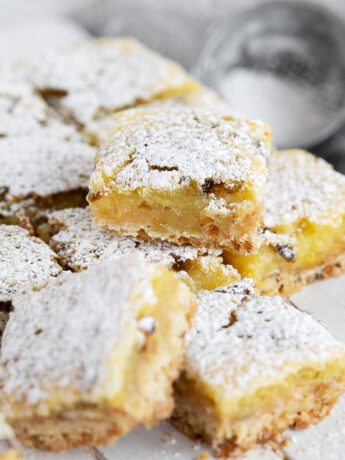 Lemon pistachio shortbread squares cut on a serving board.