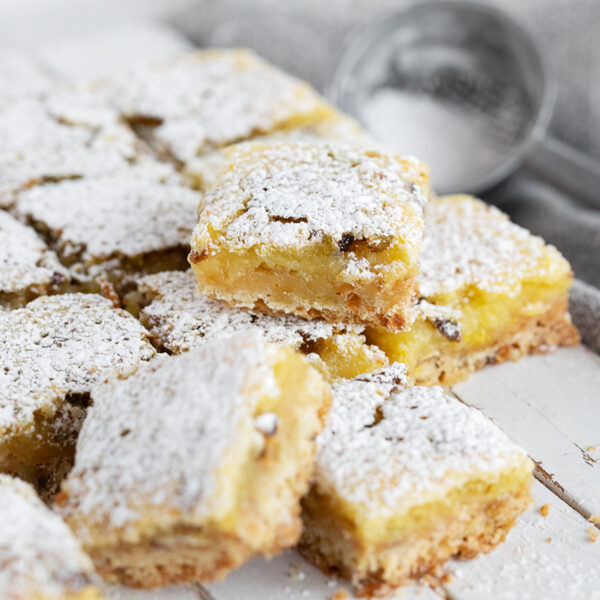 Lemon pistachio shortbread squares cut on a serving board.