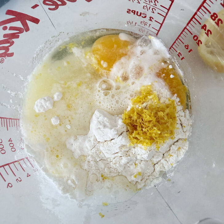 Adding the lemon filling ingredients to a measuring cup.