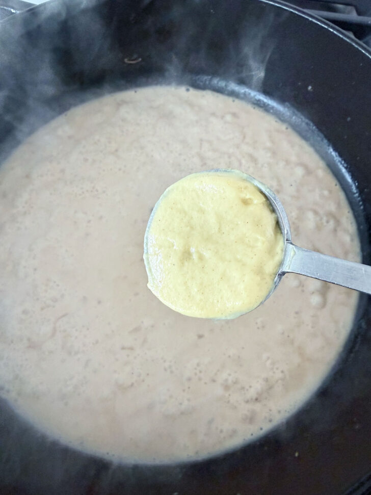 Adding the Dijon mustard to the sauce.