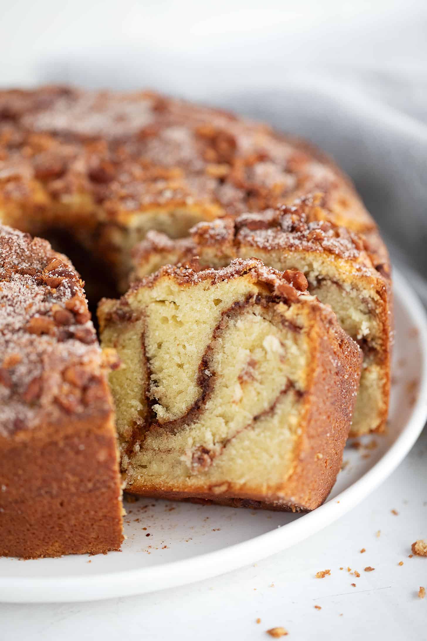 Tube pan sour cream coffee cake on a serving plate.