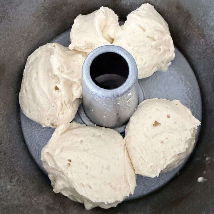 Spooning part of the batter into the tube pan.