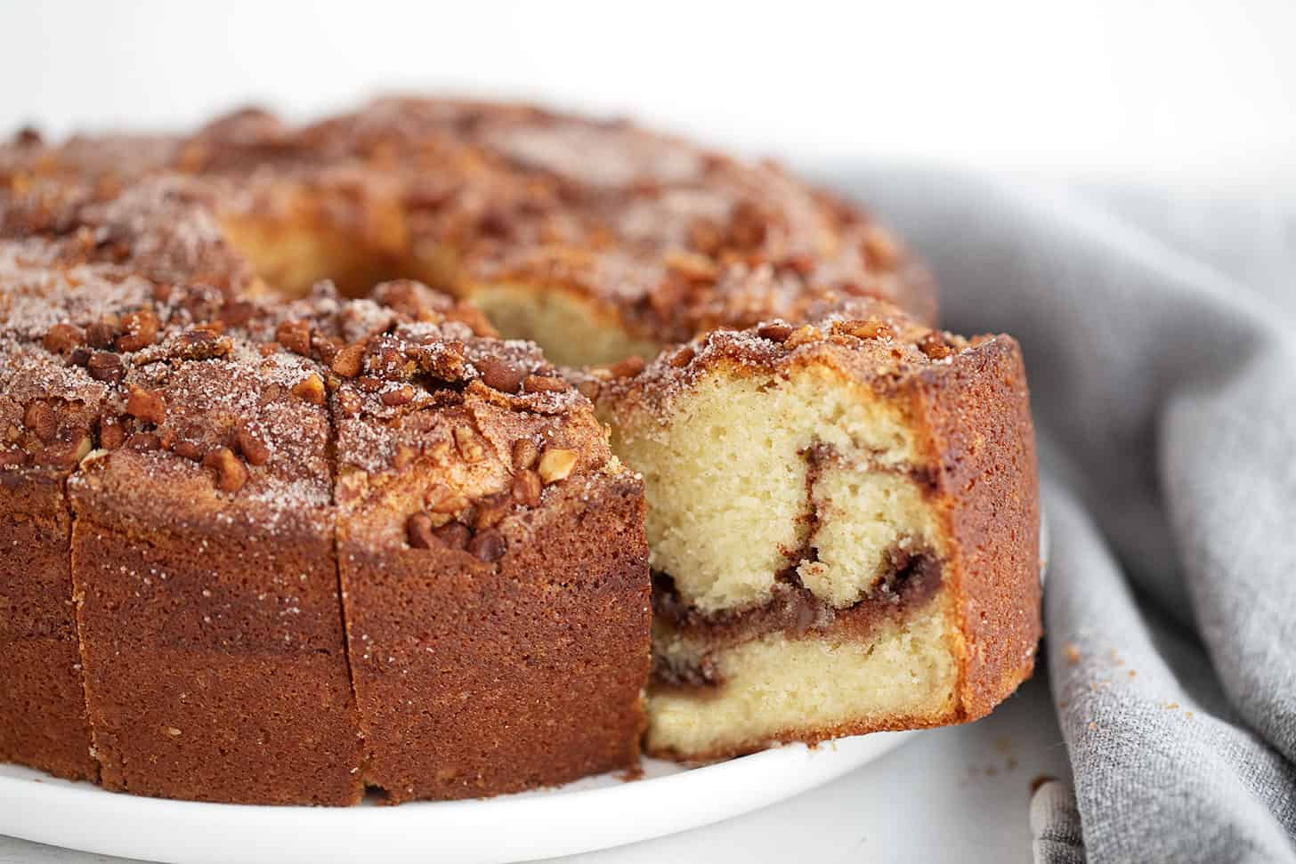 Tube-pan coffee cake sliced on a serving platter.