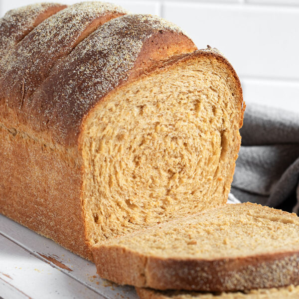 Anadama Bread sliced on a cutting board.