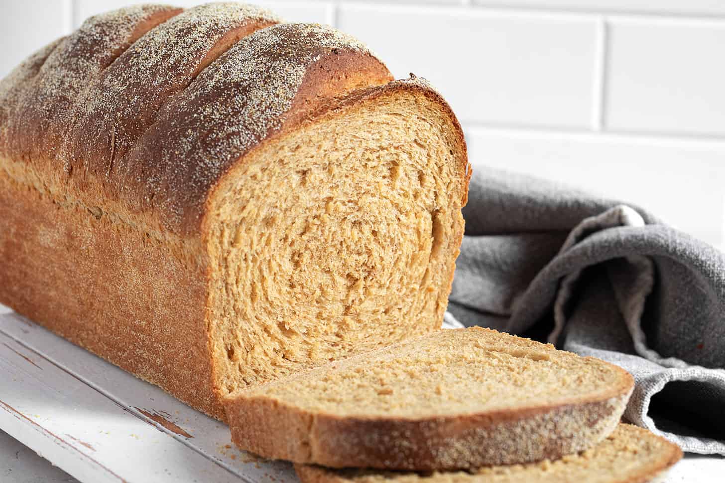 Anadama Bread sliced on a cutting board.