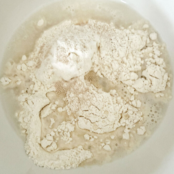 Starter dough ingredients in a small bowl.