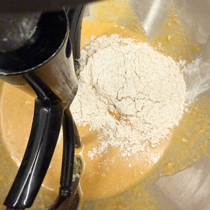 Adding whole wheat flour to the dough.