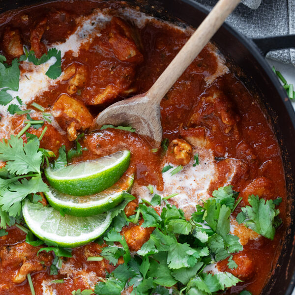 Chicken Tikka Masala in a skillet with a spoon.