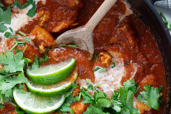 Chicken Tikka Masala in a skillet with a spoon.