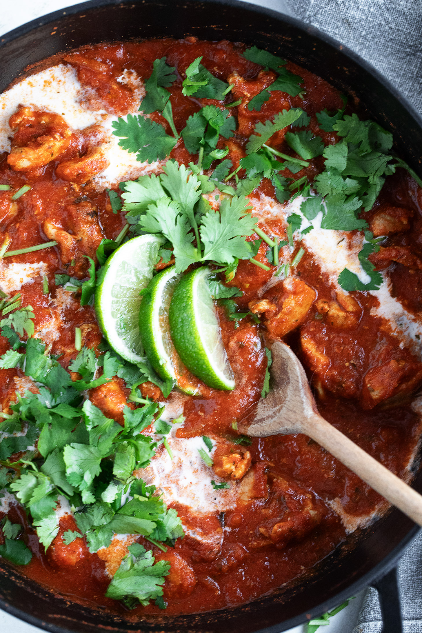 Chicken tikka masala in a skillet with a spoon.