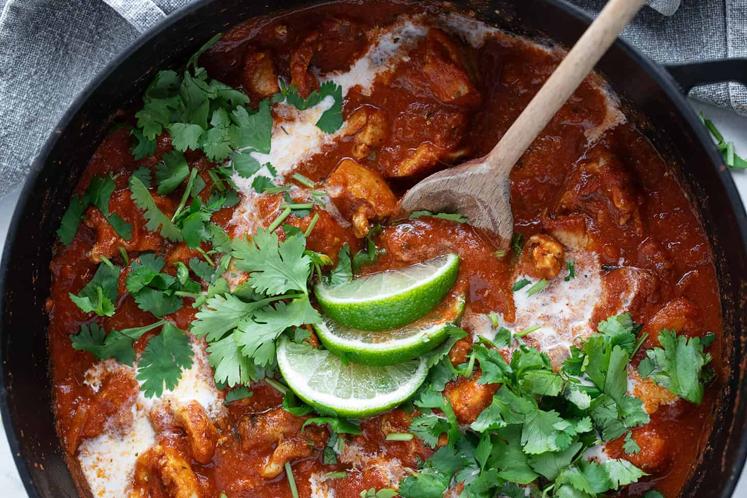 Chicken Tikka Masala in a skillet with a spoon.