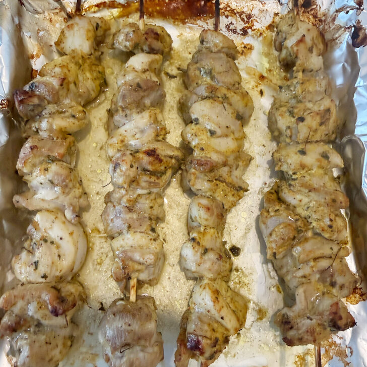 Chicken skewers after cooking on the baking sheet.