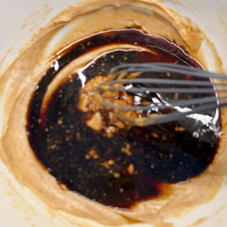 Adding the soy sauce and rice vinegar to the sauce.