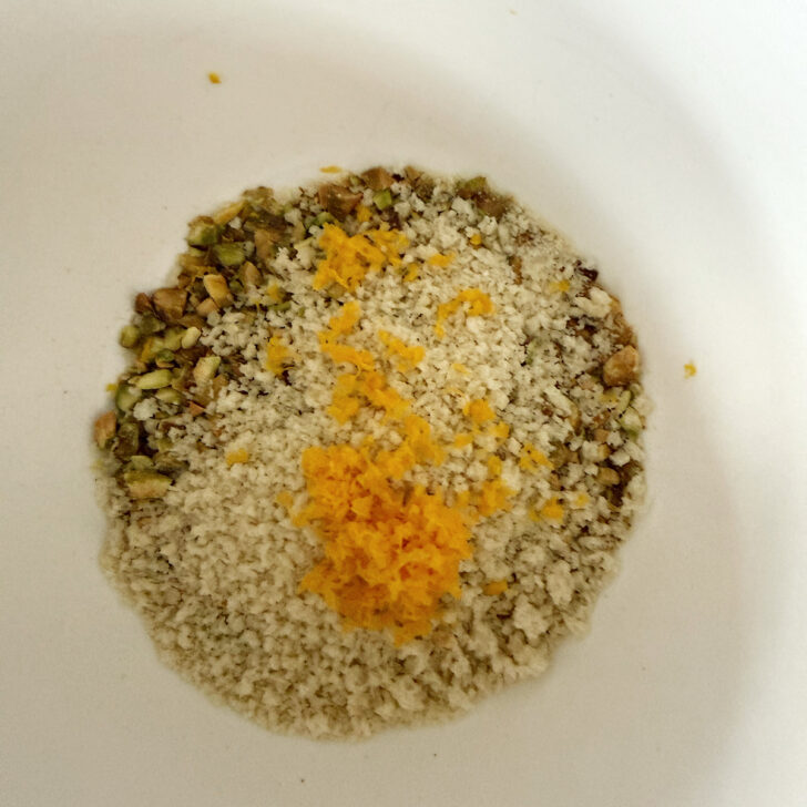 Pistachio salmon topping ingredients in a small bowl.