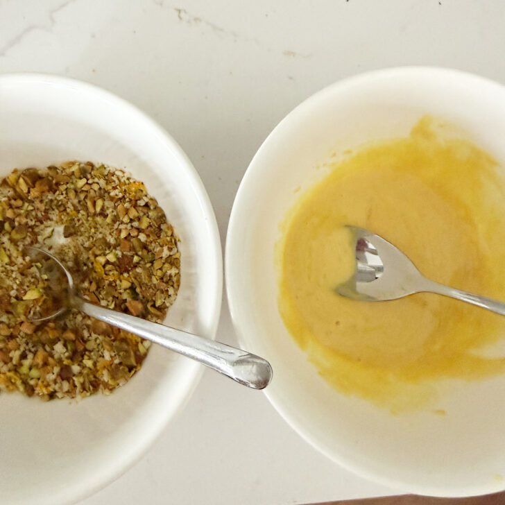 Pistachio topping and mustard mixture in small bowls.