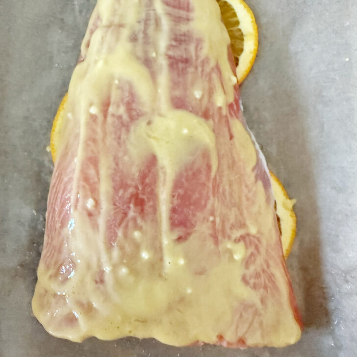 Mustard mixture rubbed onto the salmon.