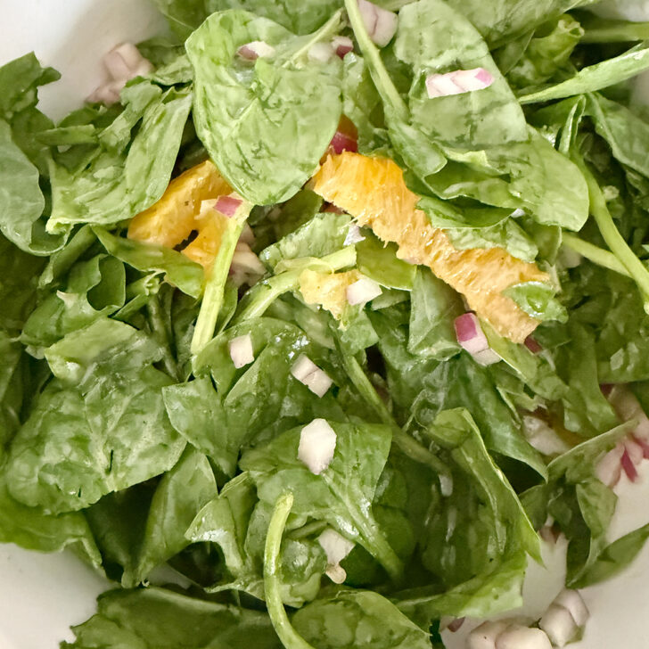 Spinach orange salad tossed together.