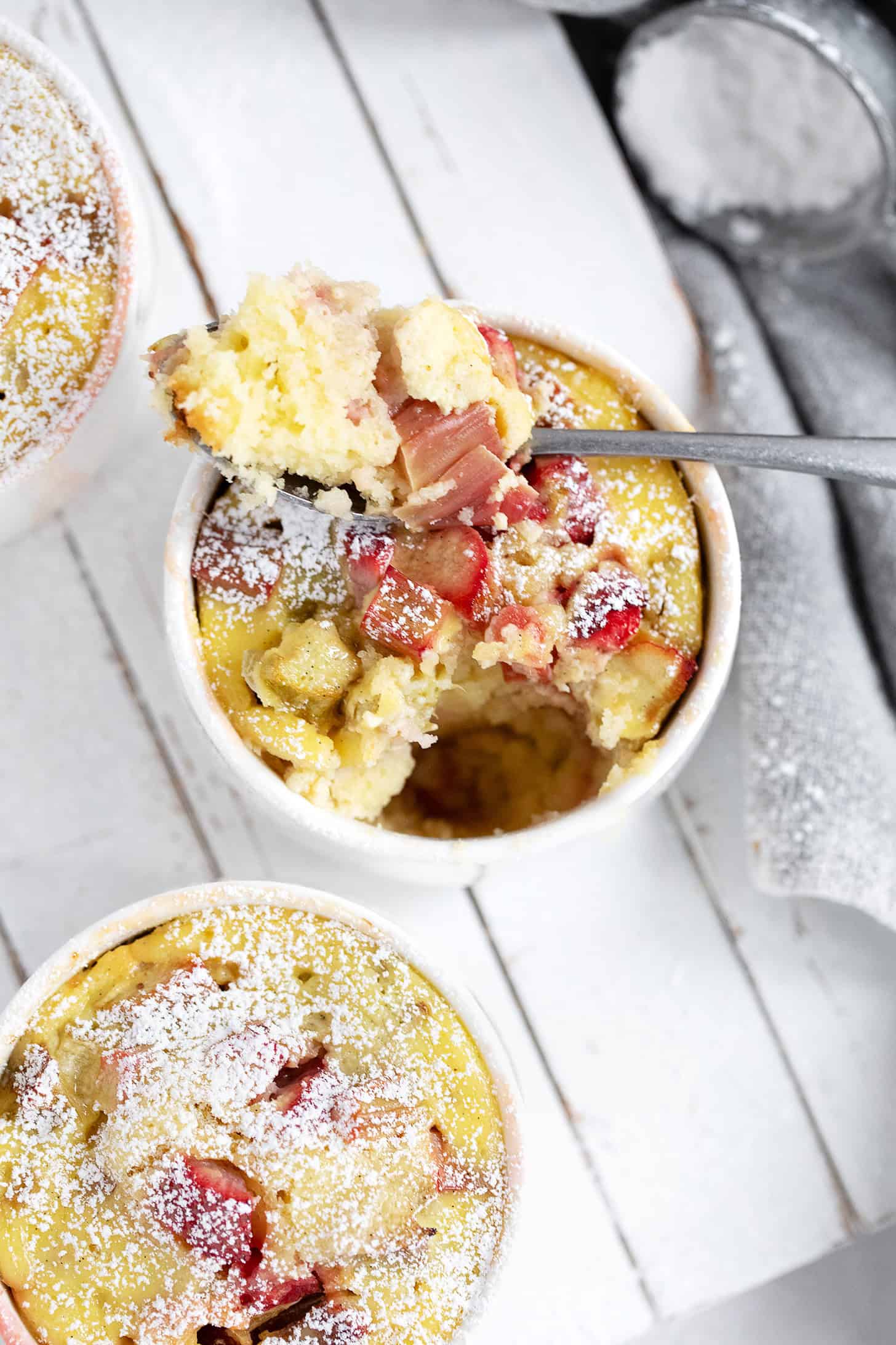 Rhubarb custard cake cups on a serving platter.