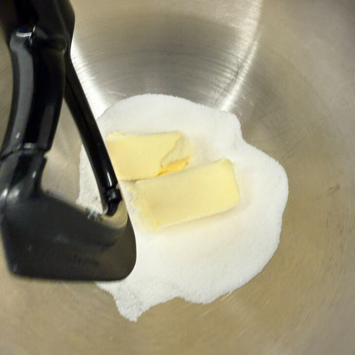 Butter and sugar in the bowl of a stand mixer.
