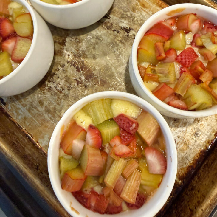 Cake cups removed from the oven partway through baking.