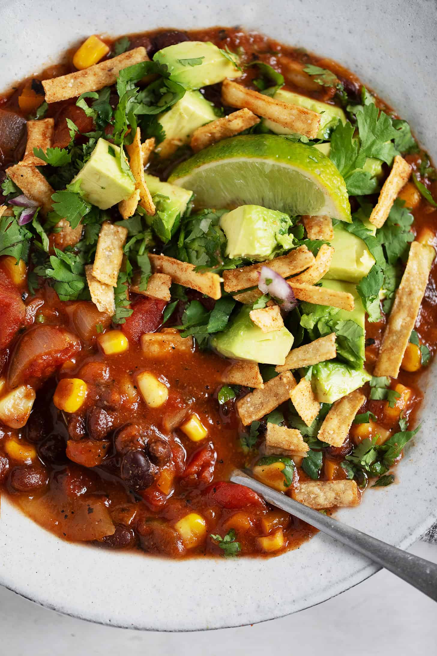 Southwest black bean and corn chili in a bowl with toppings.