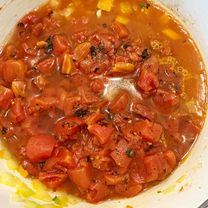 Fire-roasted diced tomatoes added to the pot.