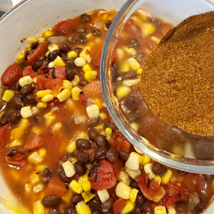 Adding the spices to the pot.