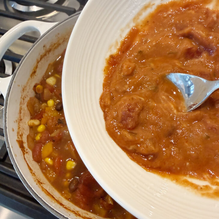 Adding the salsa and cornstarch to the chili.