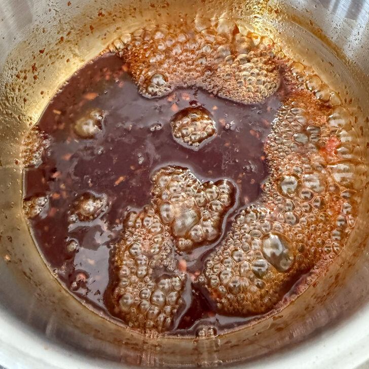 Hot honey glaze simmering in the saucepan.