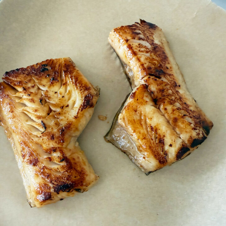 Seared cod on parchment paper.