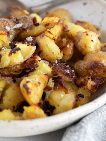 Salt and vinegar flavoured oven-roasted potatoes in a bowl.