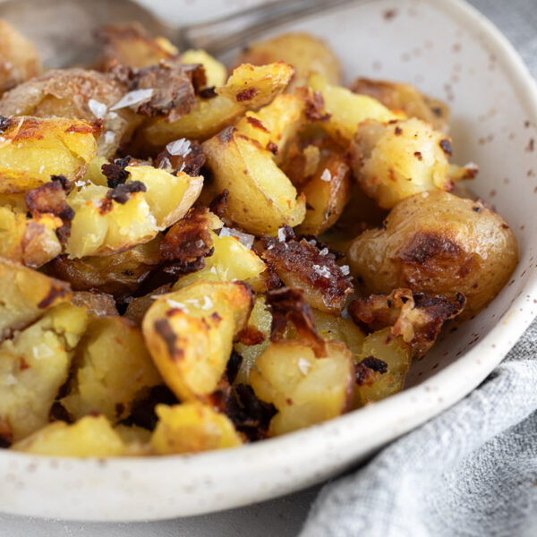 Salt and vinegar flavoured oven-roasted potatoes in a bowl.
