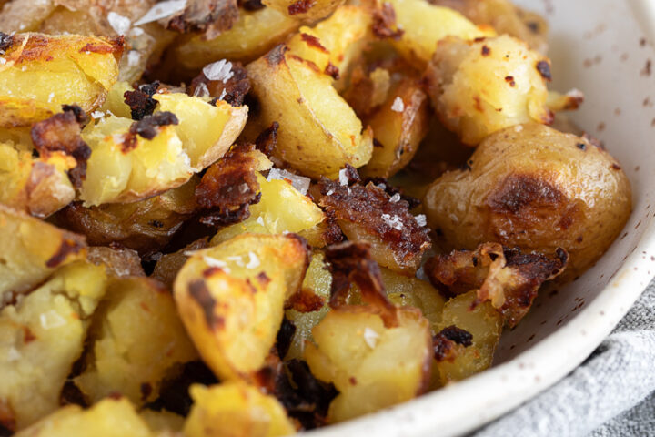 Salt and vinegar flavoured oven-roasted potatoes in a bowl.