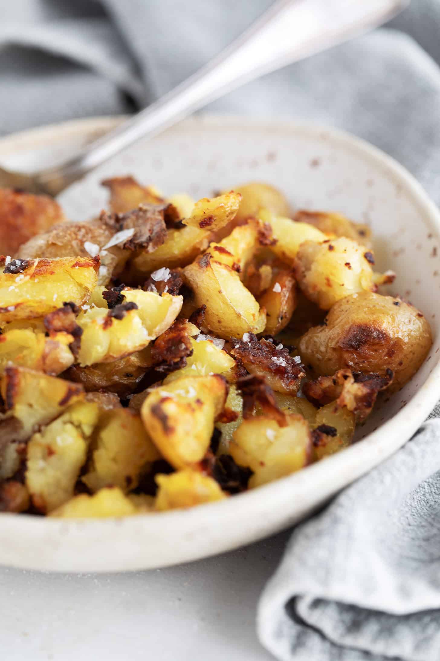 Salt and vinegar flavoured oven-roasted potatoes in a bowl.