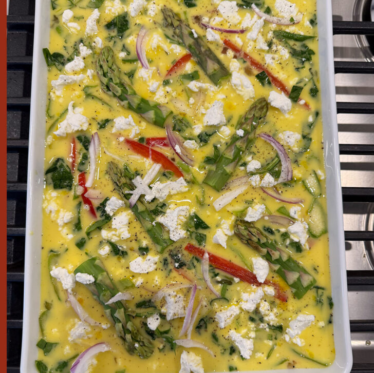 Sheet pan asparagus frittata assembled in the pan.