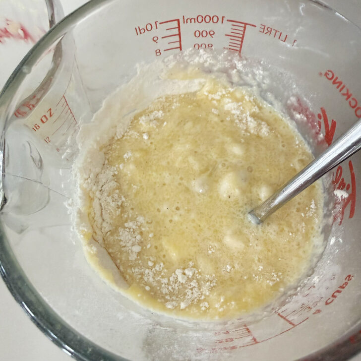 Adding the dry ingredients to the wet ingredients.