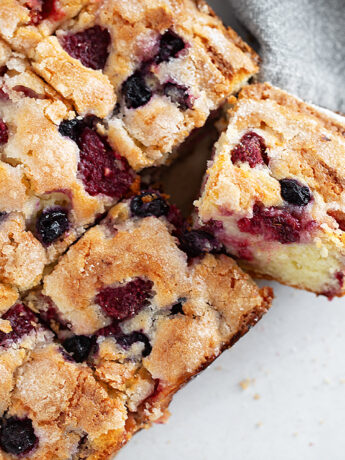 Mixed berry yogurt cake sliced.