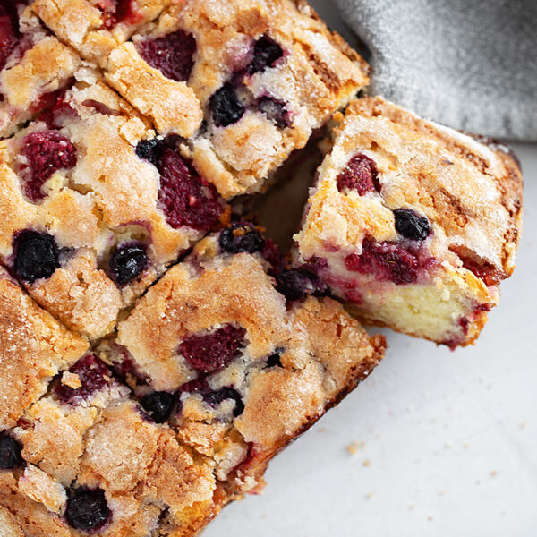 Mixed berry yogurt cake sliced.