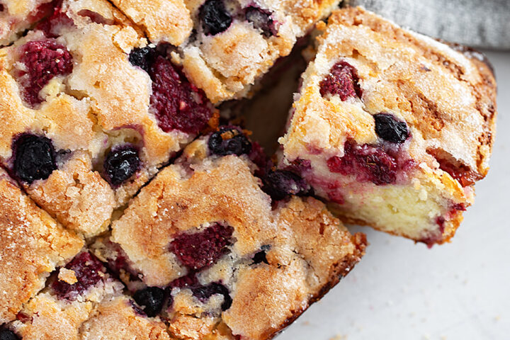 Mixed berry yogurt cake sliced.