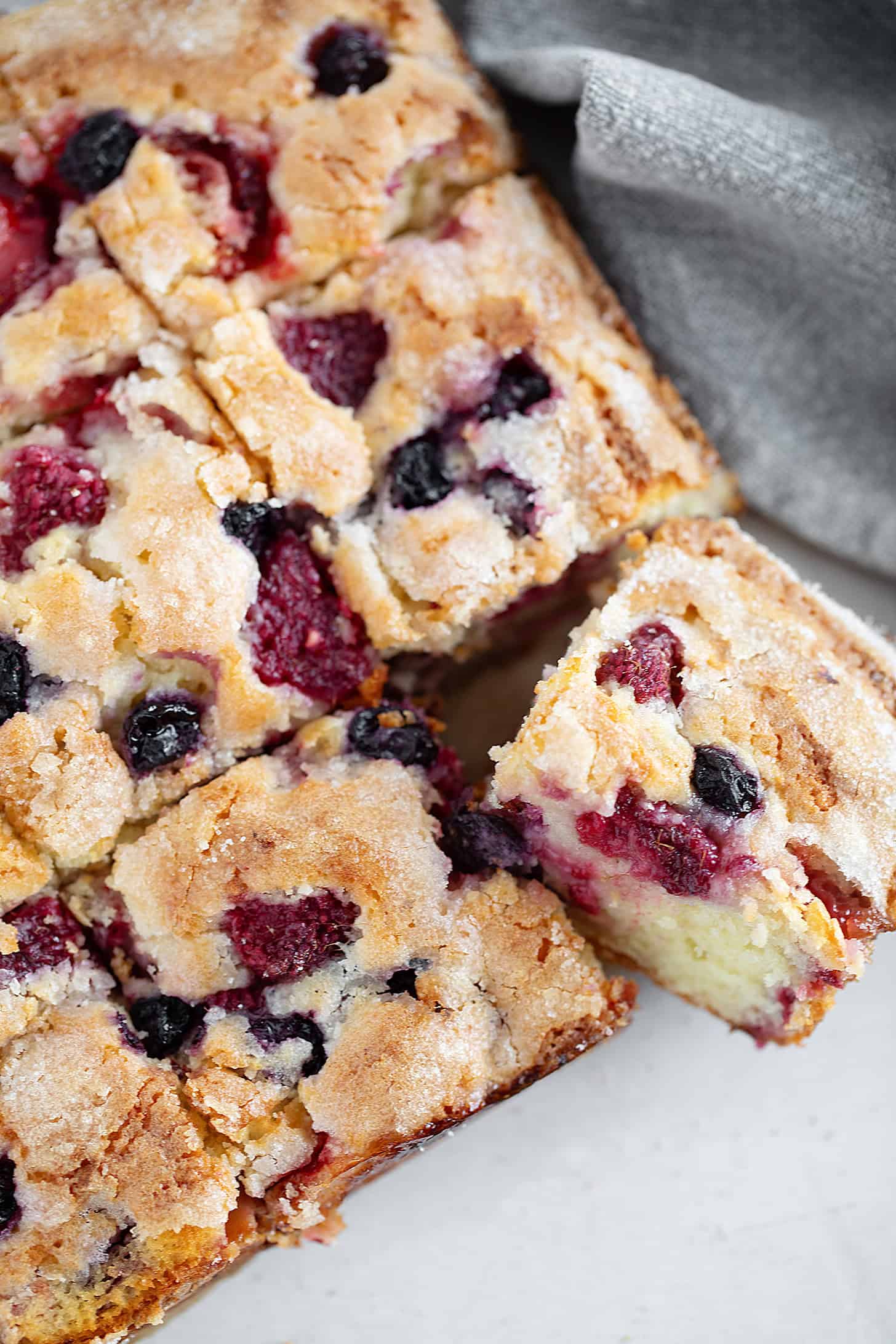 Mixed berry yogurt cake sliced.