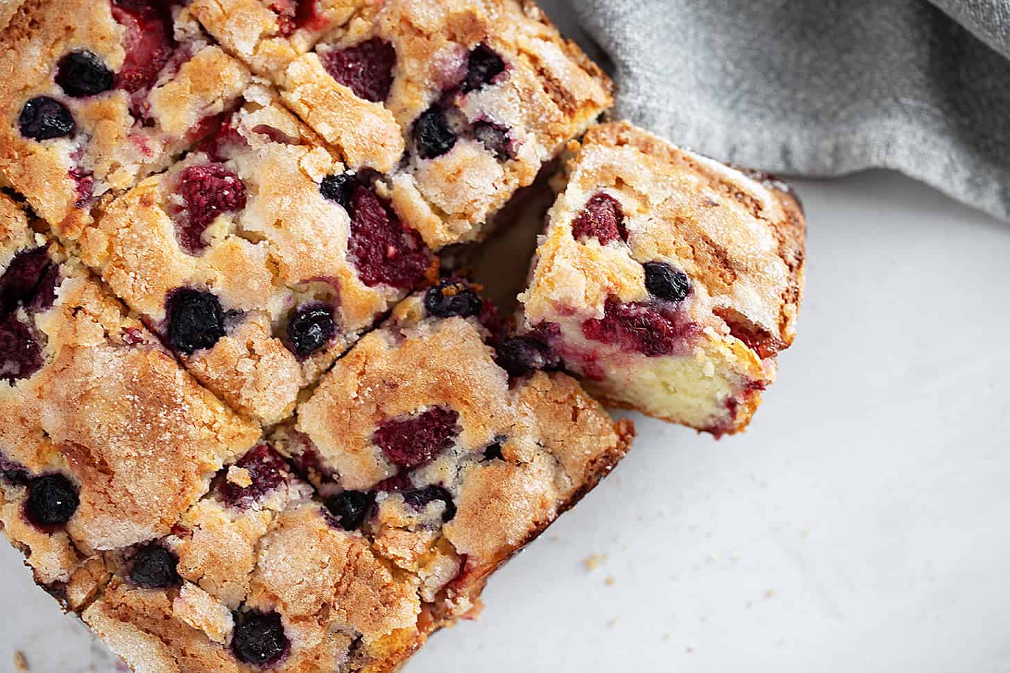 Mixed berry yogurt cake sliced.