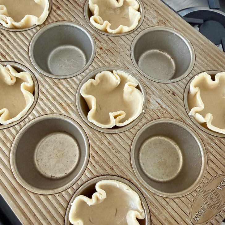 Pastry rounds fitted into muffin cups for the tarts.
