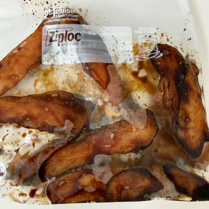 Chicken pieces and marinade in a plastic zipper bag.