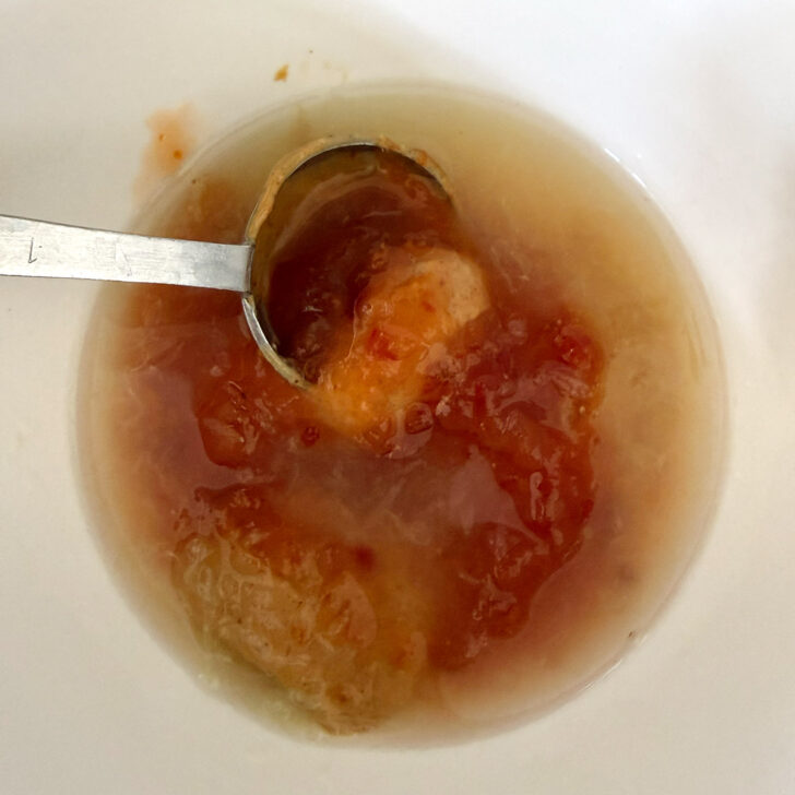 Peanut sauce ingredients added to a small bowl.